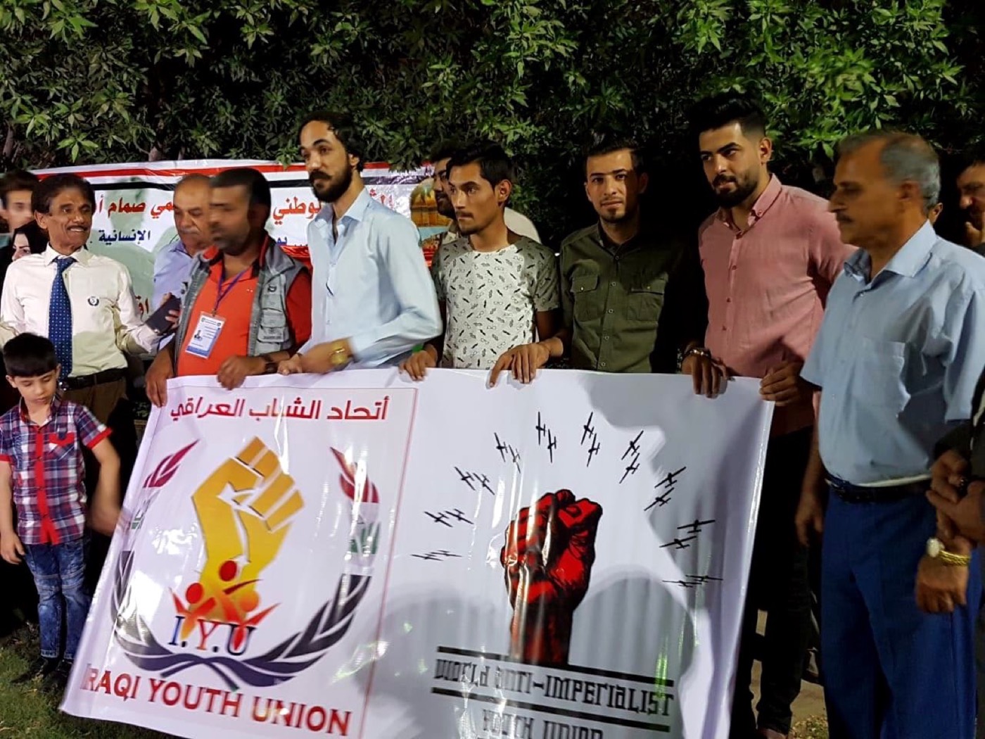 WAYU and the Iraqi Youth Union holding their banners together in Baghdad
